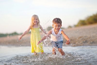 Portrait of a boy and girl on the beach in summer